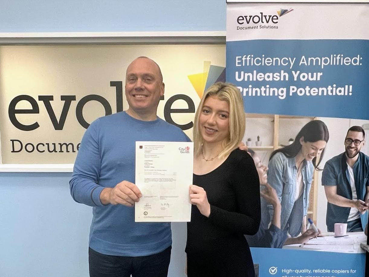 Finley Worden celebrates her Business Adminsitration certificate with Evolve Document Solutions owner Daniel Maddox