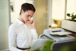 Office printer on a desk consuming resources