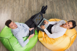 Hybrid worker using a laptop in a modern coworking space.