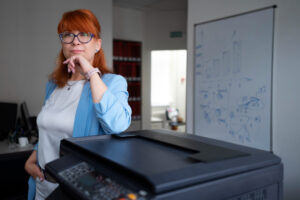 Office copier lifespan: Used copier, hourglass icon, older and newer models. Time to upgrade, maximise efficiency.